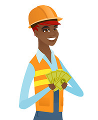 Image showing Young african-american builder holding money.