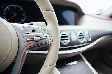 Image showing Control buttons on steering wheel. Car interior.