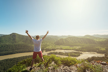 Image showing Man standing on top of cliff