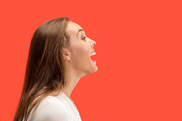 Image showing The happy business woman standing and smiling against red background.