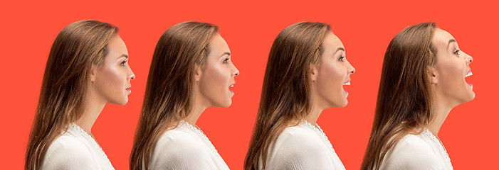 Image showing The happy business woman standing and smiling against red background.