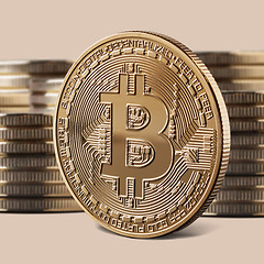 Image showing Single bitcoin gold coin standing in front of stacks of coins