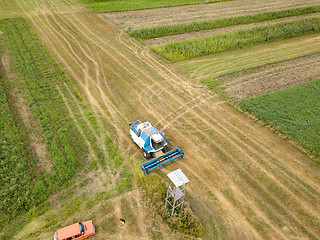 Image showing Panoramic aerial view from the drone of the field after harvest. The combine harvester reaps a crop in the field.