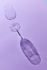 Image showing wineglass sunlight and shadow on a purple background