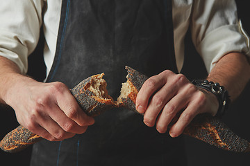 Image showing hands men break the baguette