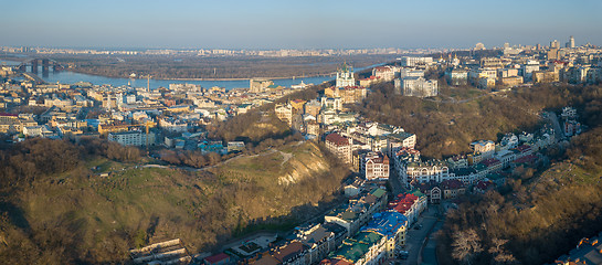 Image showing A bird\'s eye view, aerial panoramic view from drone to the Podol district, oldest historical center of Kiev, the Dnieper River and the left bank of Dnieper in the city of Kiev, Ukraine.