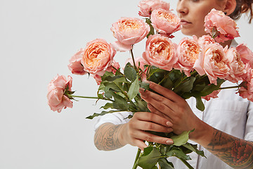 Image showing bouquet of fresh pink roses, holding a girl