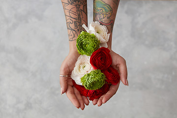 Image showing girl with a tattoo on her hands holding a bouquet of flowers