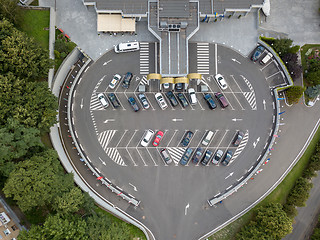 Image showing Aerial view from the drone to parking for cars of a round shape with cars on it.