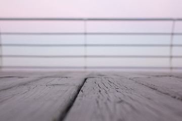 Image showing Wooden deck overlooking the sea sunrise with shallow depth of field.