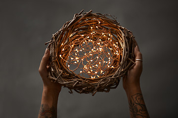 Image showing Christmas wreath made of branches decorated with a Christmas lights