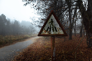 Image showing Damaged pedestrian sign at forestal road