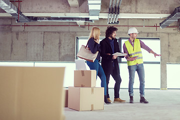 Image showing architect showing house design plans to a young couple