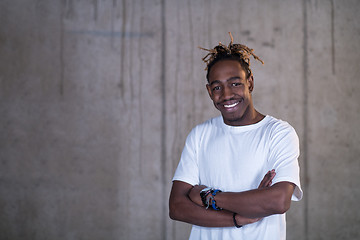 Image showing portrait of black businessman in front of a concrete wall