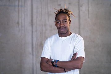 Image showing portrait of black businessman in front of a concrete wall