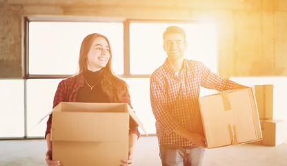 Image showing business team carrying cardboard boxes