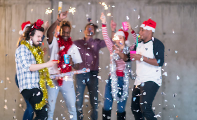 Image showing multiethnic group of casual business people having confetti part