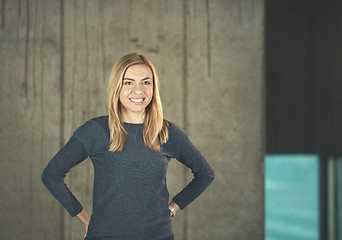 Image showing portrait of casual businesswoman in front of a concrete wall