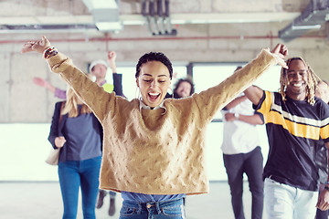 Image showing young multiethnic business people dancing in unfinished startup 