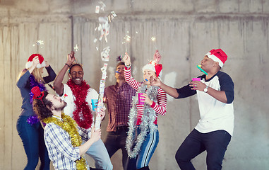 Image showing multiethnic group of casual business people having confetti part