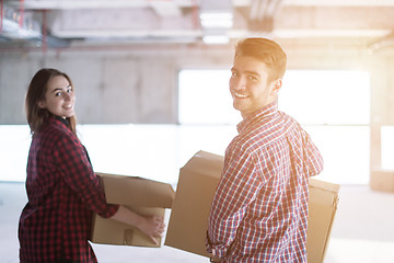 Image showing business team carrying cardboard boxes