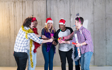 Image showing multiethnic group of casual business people lighting a sparkler