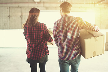 Image showing business team carrying cardboard boxes