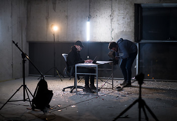 Image showing videographer recording talented hacker while working in dark off