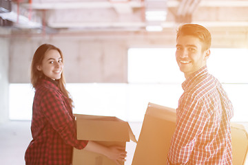 Image showing business team carrying cardboard boxes