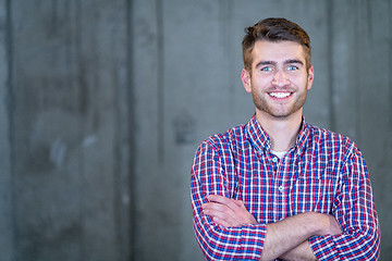 Image showing portrait of casual businessman in front of a concrete wall