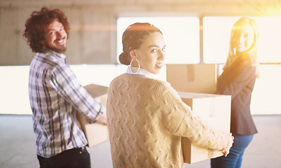 Image showing business team carrying cardboard boxes