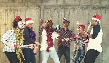 Image showing multiethnic group of casual business people having confetti part