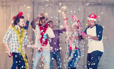 Image showing multiethnic group of casual business people having confetti part