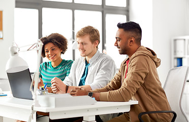 Image showing happy creative team with laptop working at office