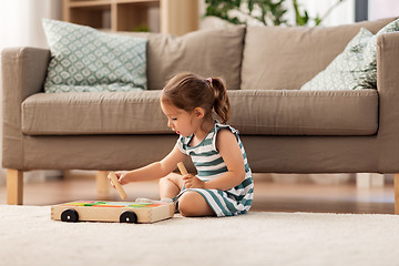 Image showing happy baby girl playing with toy blocks at home