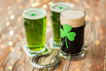 Image showing shamrock on glass of beer and horseshoe on table