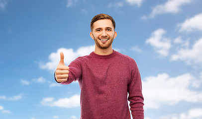 Image showing happy young man showing thumbs up