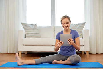 Image showing woman with tablet computer doing yoga at home