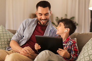 Image showing father and son listening to music on tablet pc