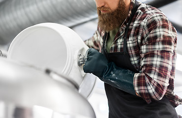 Image showing brewer working at craft brewery or beer plant