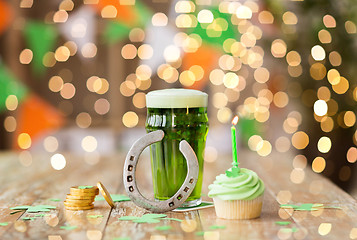 Image showing glass of beer, cupcake, horseshoe and gold coins