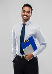 Image showing indian businessman with clipboard and notebook