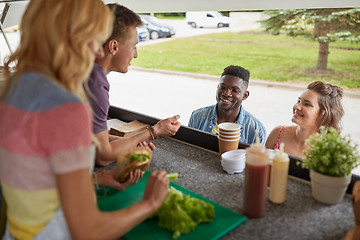 Image showing customers couple ordering hamburgers at food truck