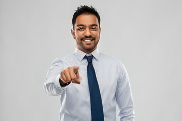 Image showing indian businessman in shirt with tie over grey