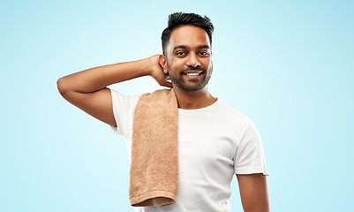 Image showing smiling indian man with towel over blue background