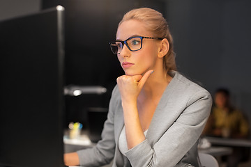 Image showing businesswoman working at computer in night office