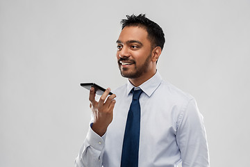 Image showing businessman using voice command on smartphone