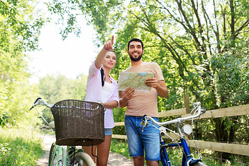 Image showing couple with map and bicycles at country in summer