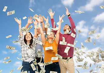 Image showing happy friends picking money falling from up above