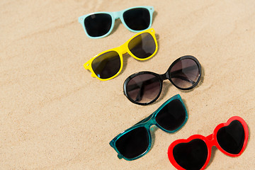 Image showing different sunglasses on beach sand